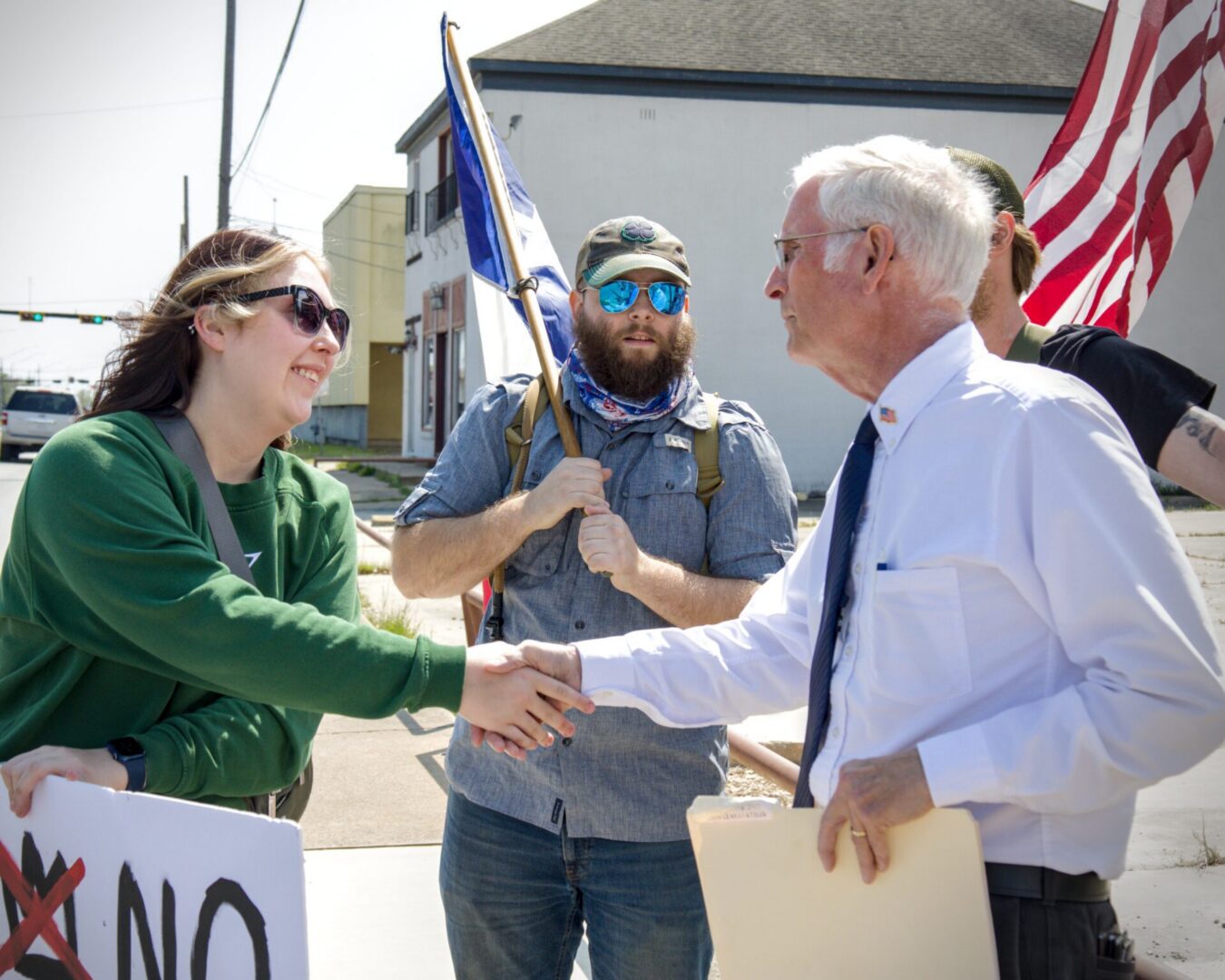 People shaking hands at outdoor protest