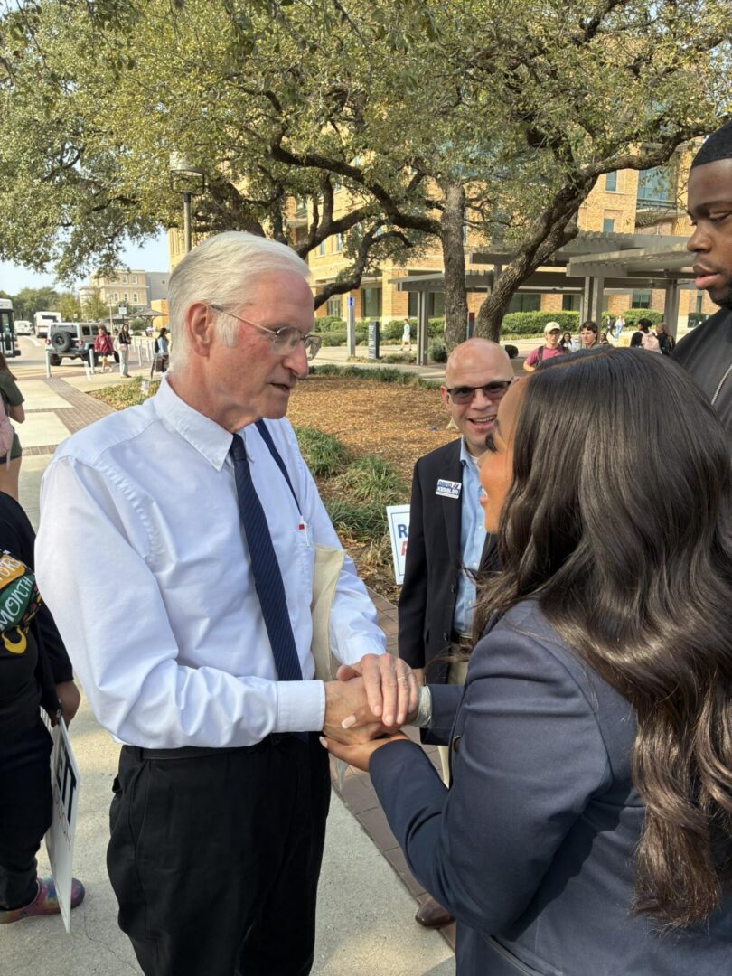 Man and woman shaking hands outdoors