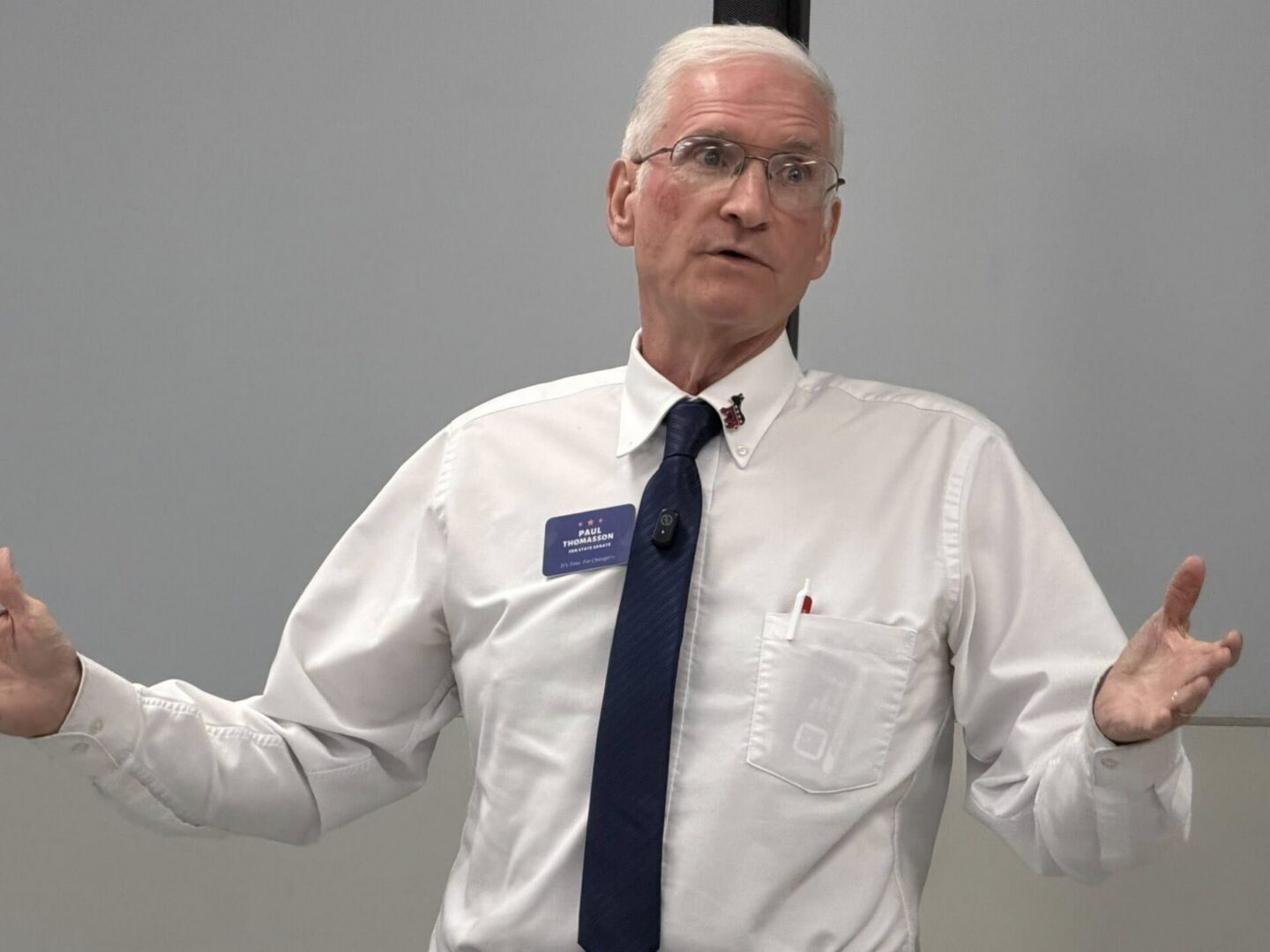 Man in white shirt and tie speaking